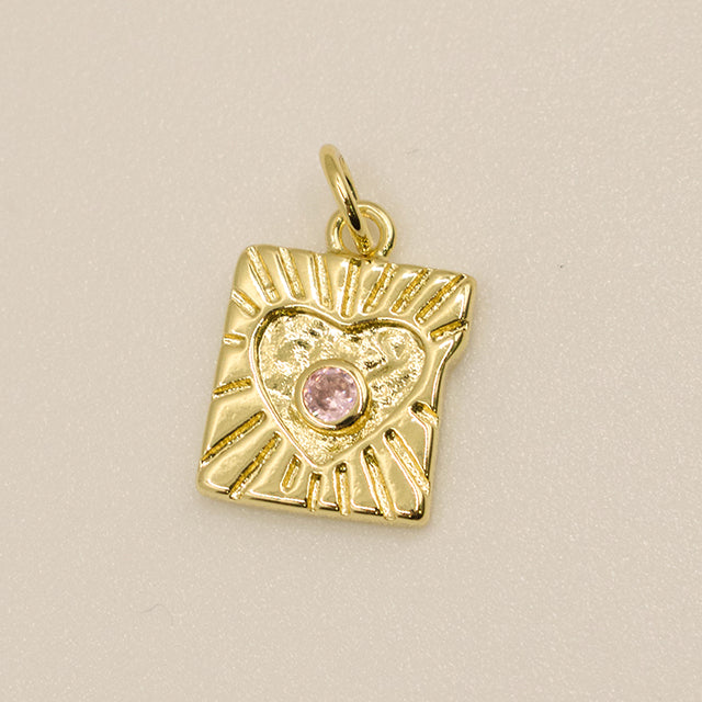 Dije Corazón Radiante con Piedra Rosa y Rayos de Sol Dorados