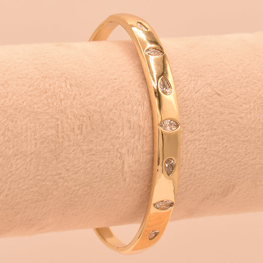 Pulsera Rígida Dorada con Circonitas Marquise